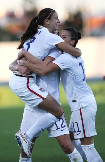 Alex Morgan celebrates with Lauren Holiday and Ali Krieger after scoring the first U.S. goal against Switzerland on March 6, 2015, at the Estadio Municipal in Vila Real de Santo Antonio, Portugal, in the second round of group play in the Algarve Cup. The United States won 3-0. (Cristina Quicler/AFP/Getty Images)